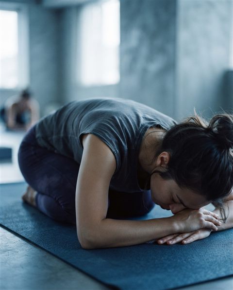 Cinematic film still of yoga practice, close-up detail with shallow depth of field, cool blue tones, quiet atmosphere, 4:5 aspect ratio
