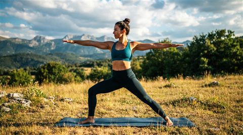Photorealistic photo of yoga practice, centered subject with a simple uncluttered composition, vivid colors, high contrast, energetic, 16:9 aspect ratio